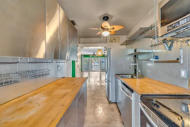a kitchen with stainless steel appliances granite countertop a sink and cabinets