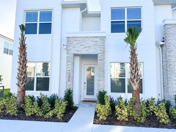 front view of a house with a potted plant