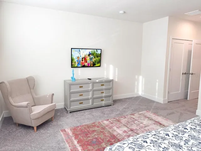 a bathroom with a granite countertop sink a toilet and a large mirror