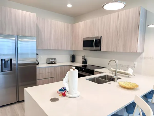 a kitchen with a sink and a refrigerator
