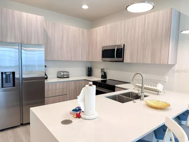 a kitchen with a sink and a refrigerator