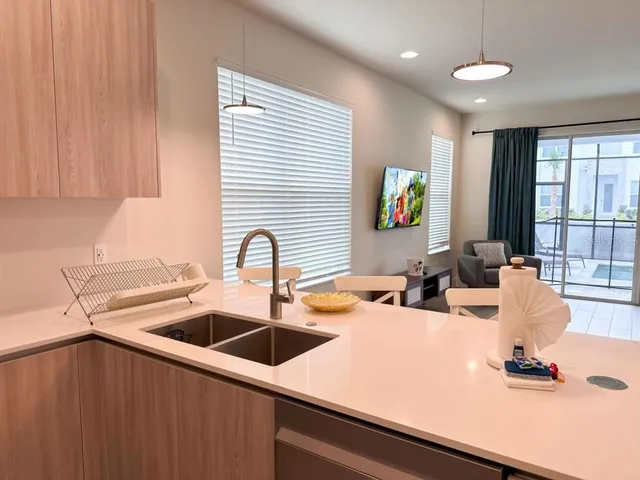 a view of a kitchen area with furniture and wooden floor