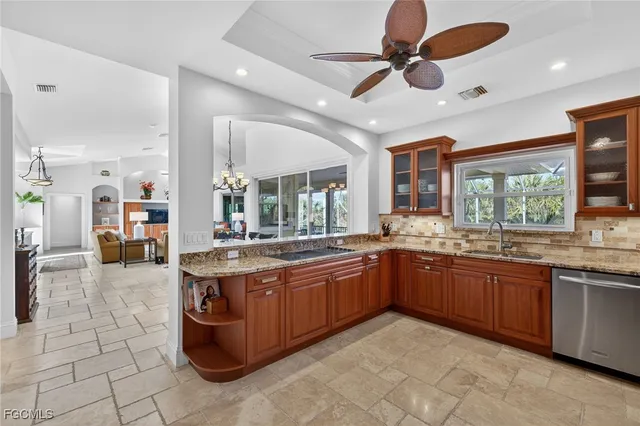a large kitchen with stainless steel appliances granite countertop cabinetry and a sink