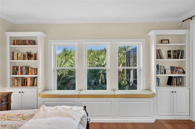 a living room with furniture and large window
