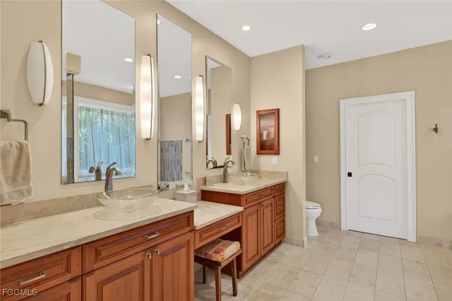 a bathroom with a double vanity sink a mirror and a bathtub