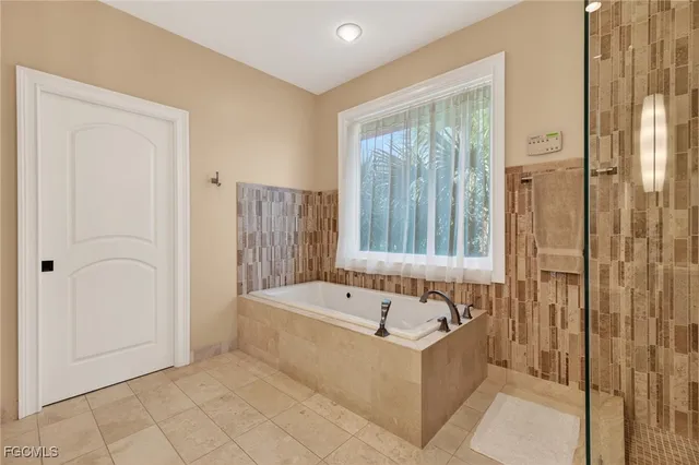 a bathroom with a bathtub and shower