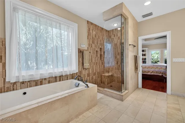 a bathroom with a bathtub and a shower