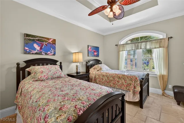 a bedroom with two beds and a window