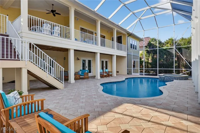 a view of a house with pool fire pit and a wooden floor