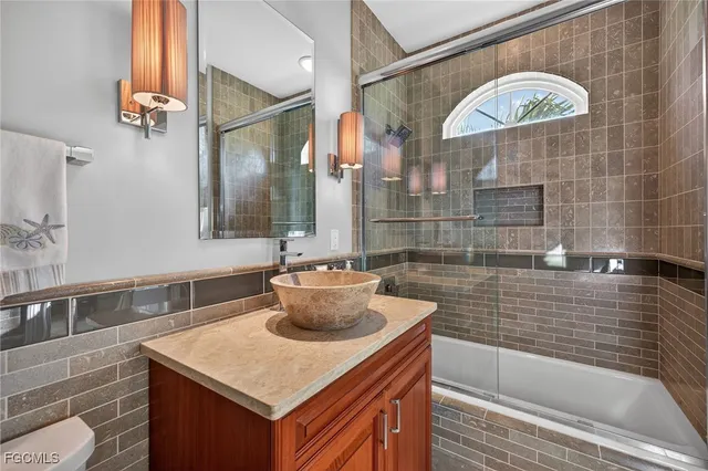 a bathroom with a sink a mirror and a bathtub