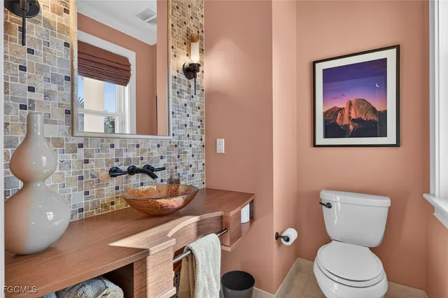 a bathroom with a toilet a sink and a mirror