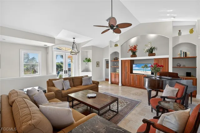 a living room with furniture kitchen view and a window