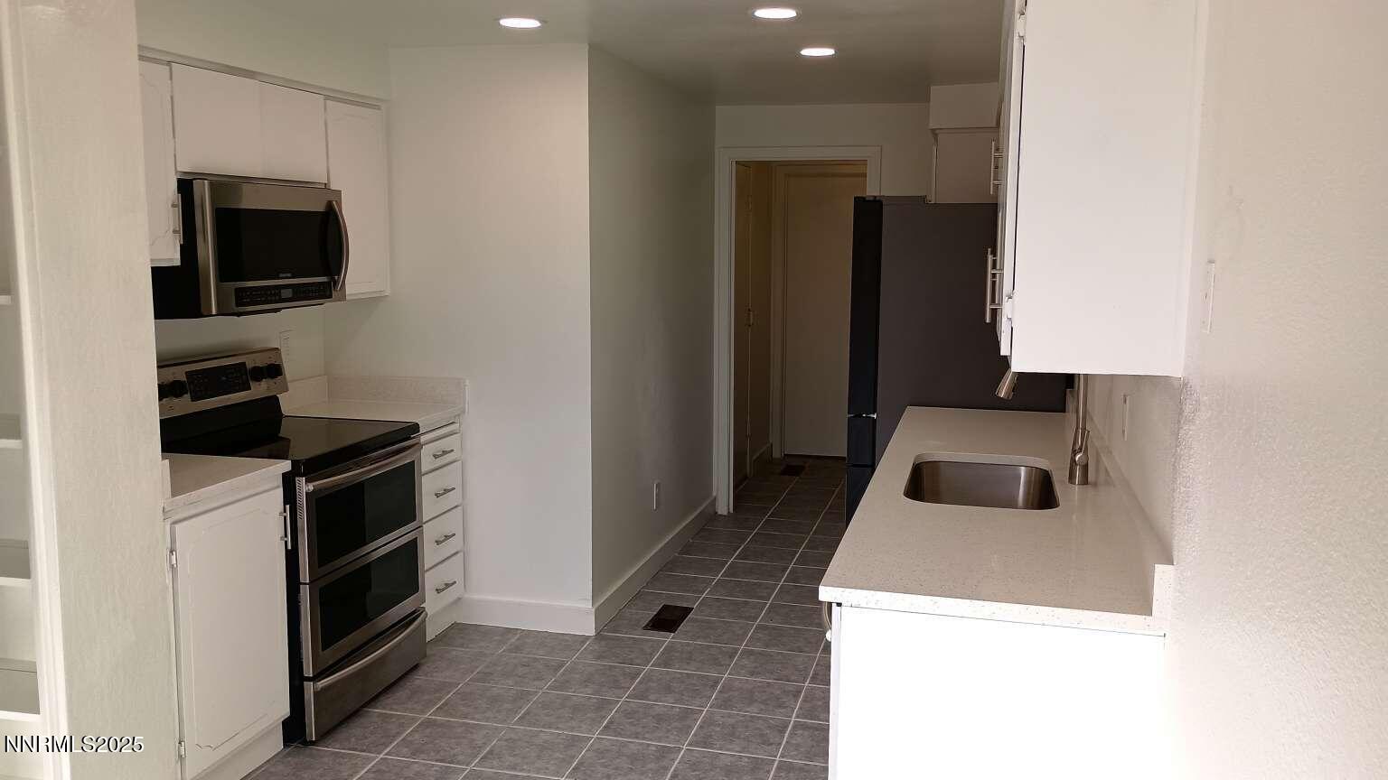 68 Condor Circle Carson City, NV 89701 - Photo 12 of 23 a kitchen that has a sink and a stove in it