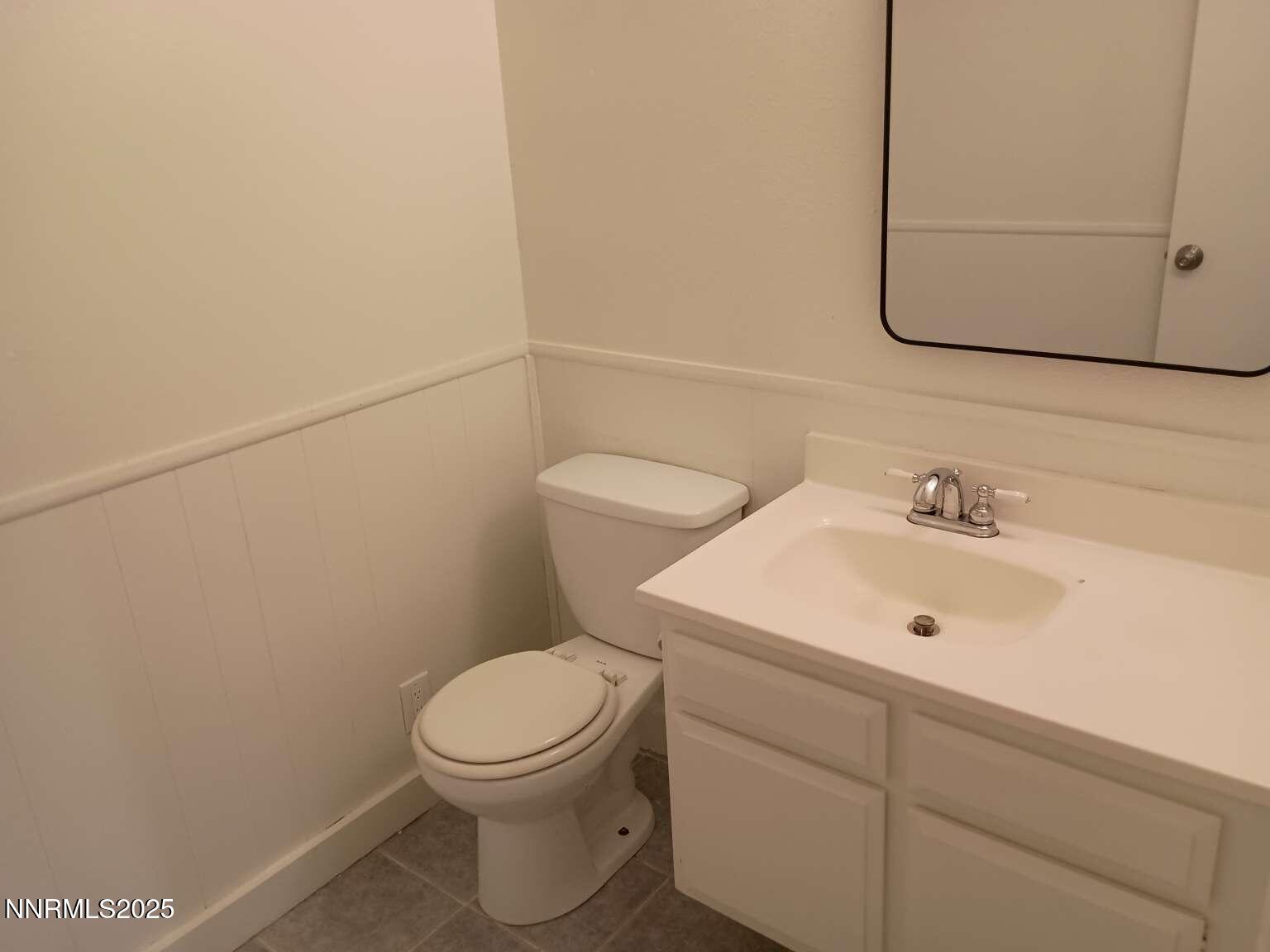68 Condor Circle Carson City, NV 89701 - Photo 14 of 23 a bathroom with a toilet a sink and mirror