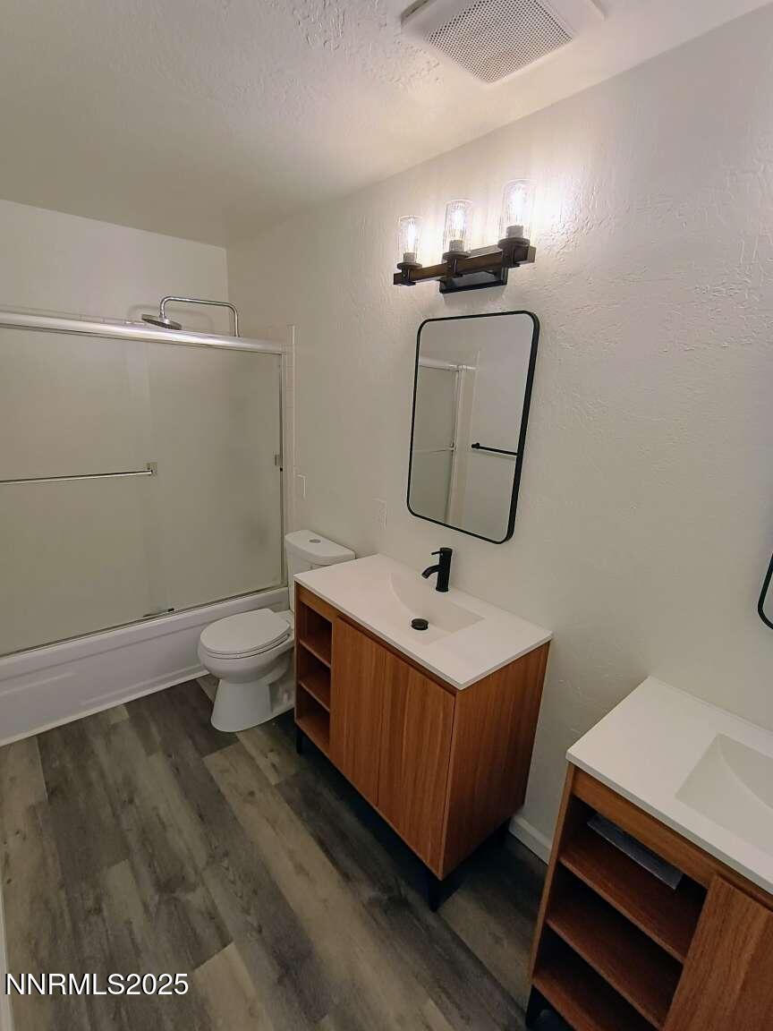 68 Condor Circle Carson City, NV 89701 - Photo 19 of 23 a bathroom with a toilet a sink and mirror