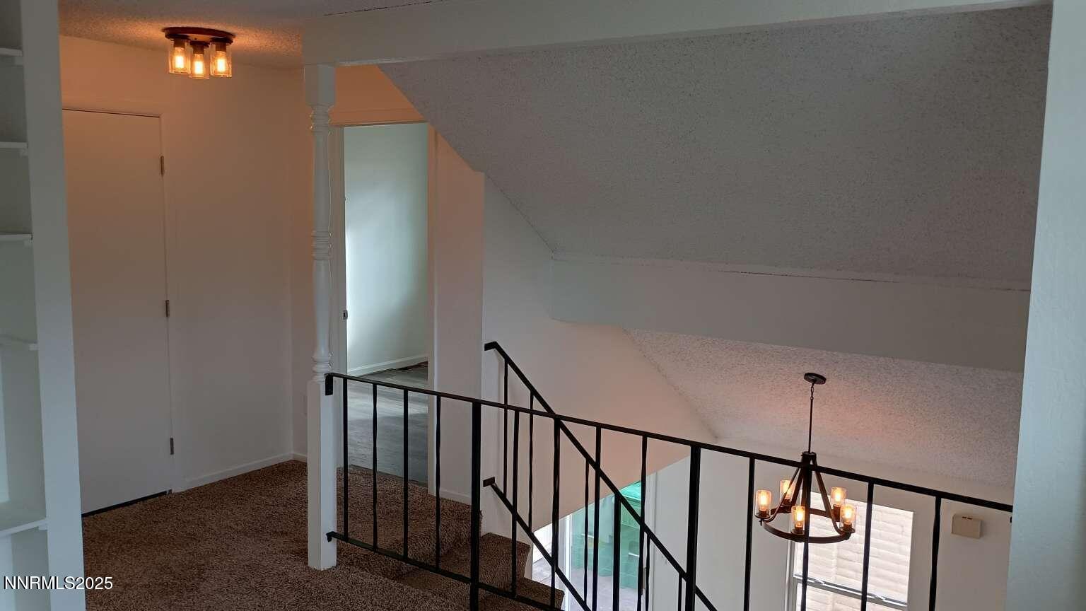 68 Condor Circle Carson City, NV 89701 - Photo 22 of 23 a view of staircase with railing and a chandelier
