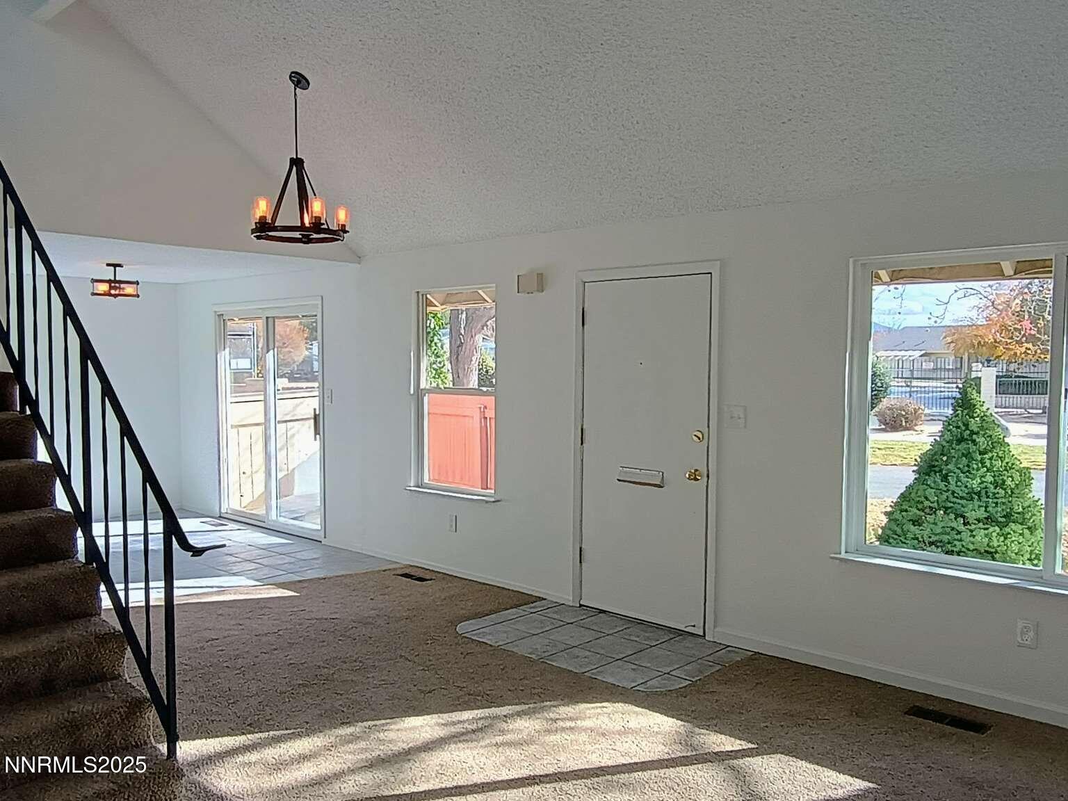 68 Condor Circle Carson City, NV 89701 - Photo 5 of 23 a view of an entryway with wooden floor and windows