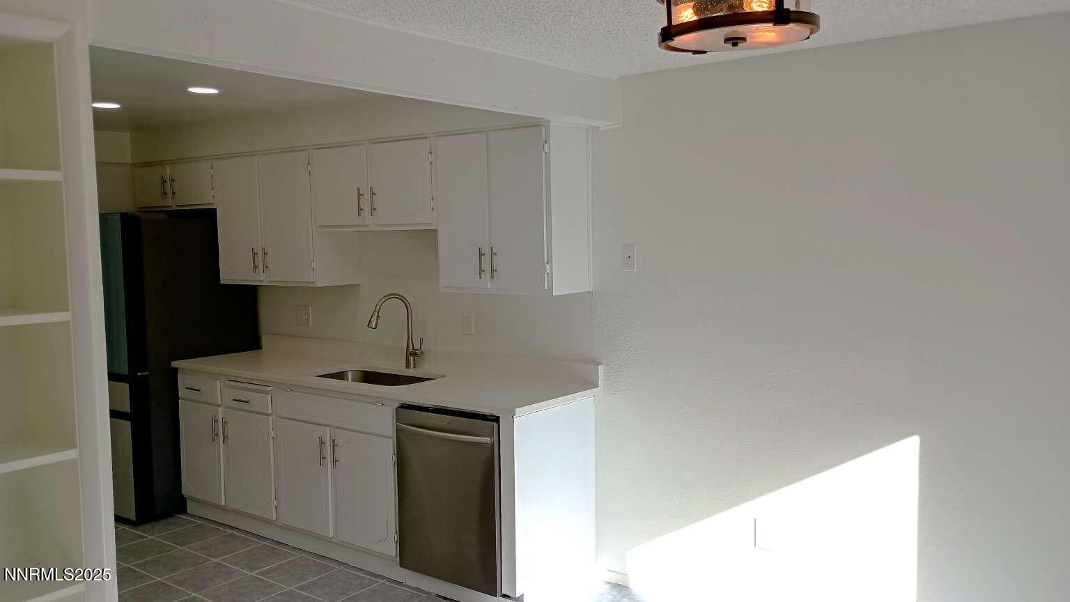 68 Condor Circle Carson City, NV 89701 - Photo 10 of 23 a kitchen with a sink and a refrigerator