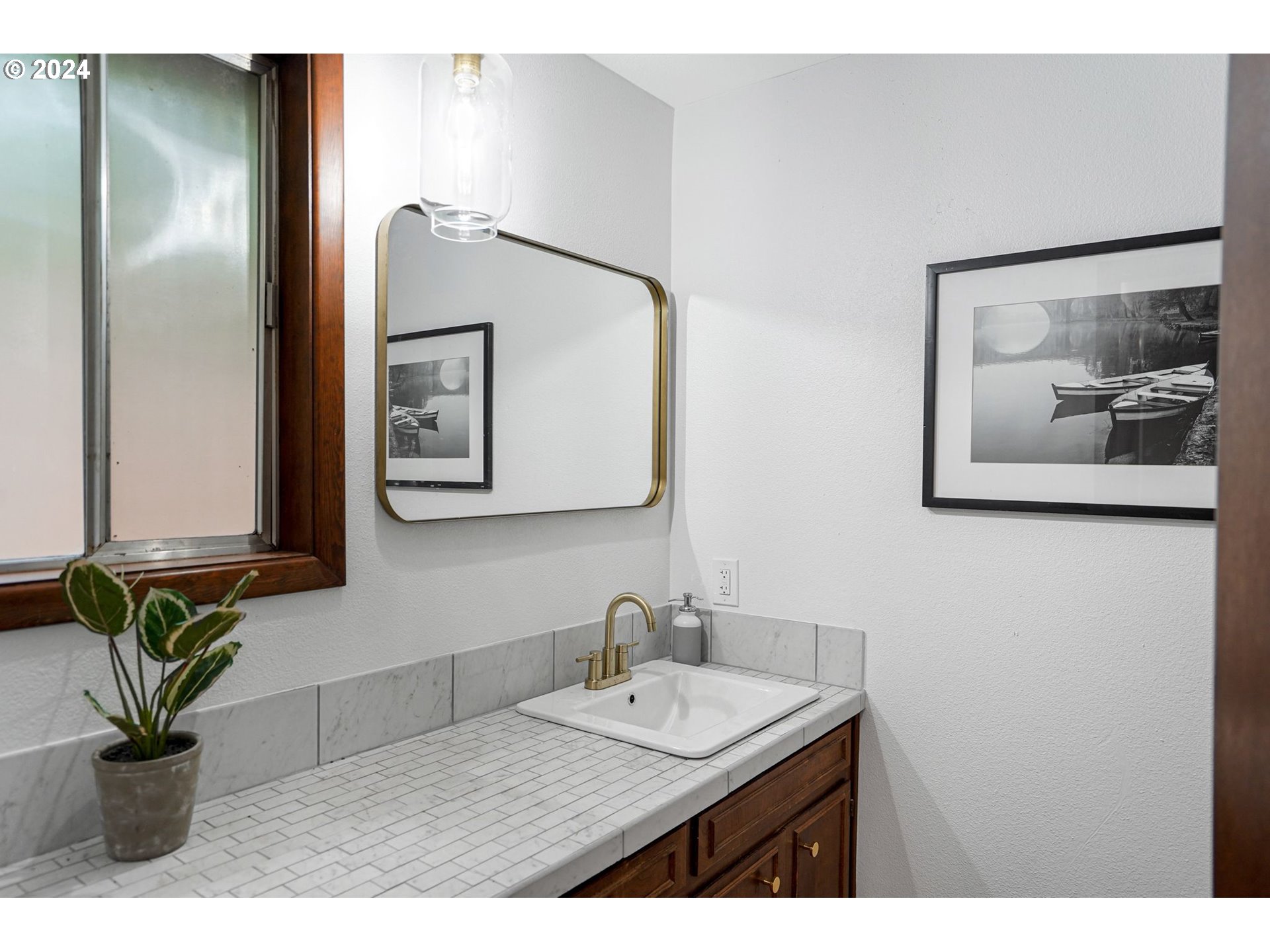 7565 Bates Road South Salem, OR 97306 - Photo 11 of 29 a bathroom with a sink a mirror and a painting