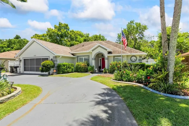 a front view of a house with swimming pool having outdoor seating