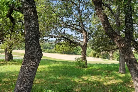 a view of outdoor space with trees all around