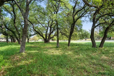 a view of grassy field with benches