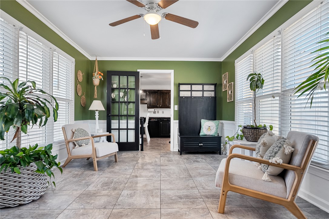 112 C-10-220 Anderson, SC 29621 - Photo 22 of 45 This bright sunroom offers a serene retreat with expansive windows and convenient access to the kitchen.
