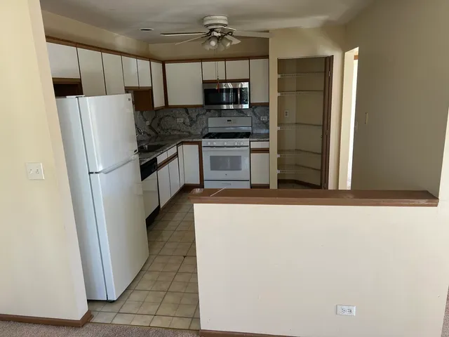 a kitchen with stainless steel appliances a refrigerator and a stove top oven