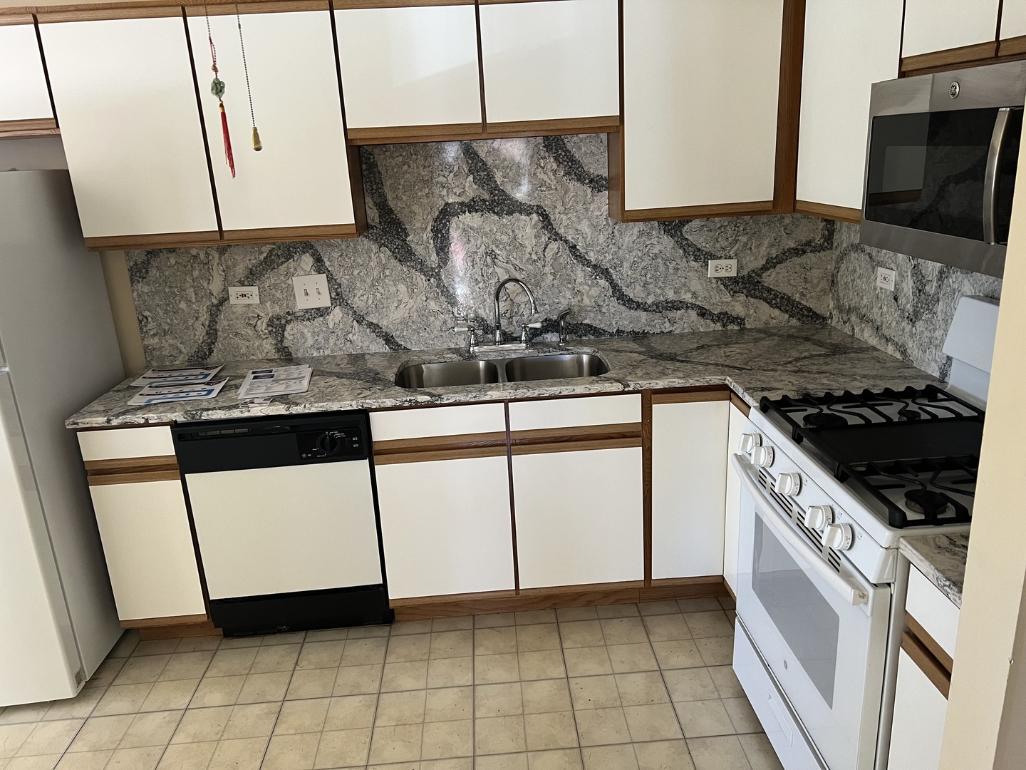 2750 Shelly Lane Aurora, IL 60504 - Photo 9 of 32 a kitchen with stainless steel appliances granite countertop a stove a sink and a microwave