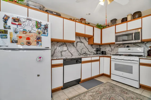 a kitchen with stainless steel appliances granite countertop a sink and a microwave
