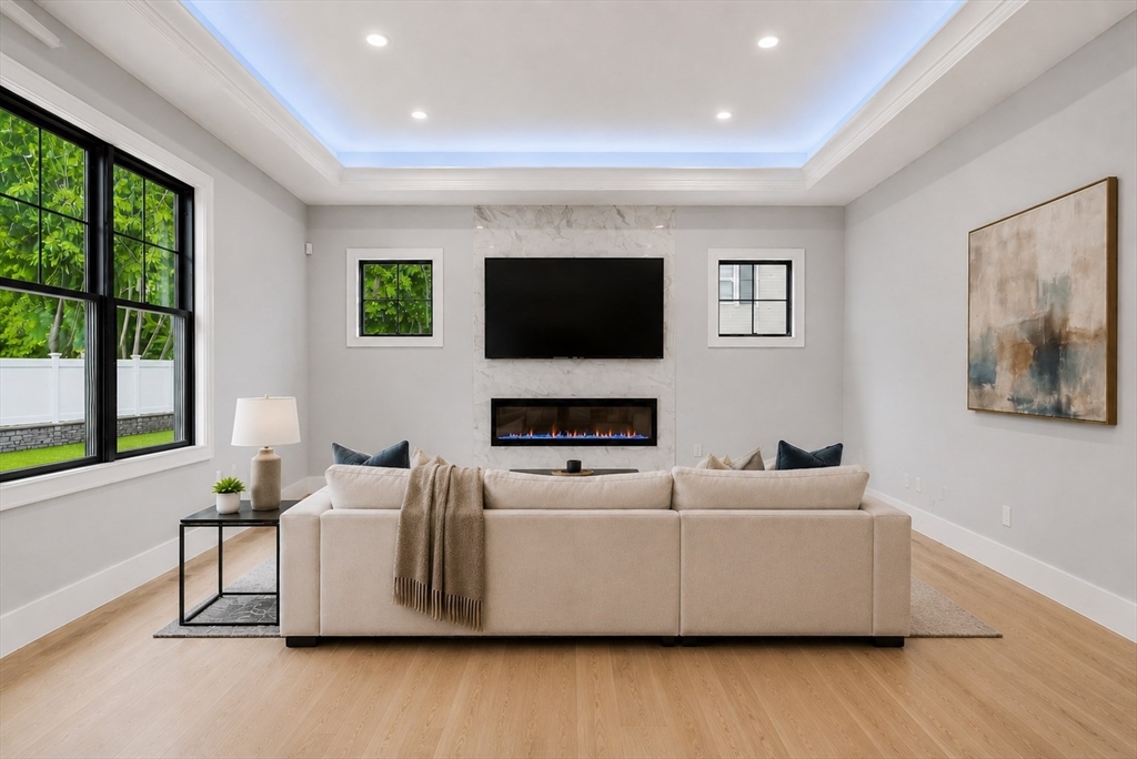 18 Avon Circle Needham, MA 02494 - Photo 6 of 18 a living room with furniture and a flat screen tv