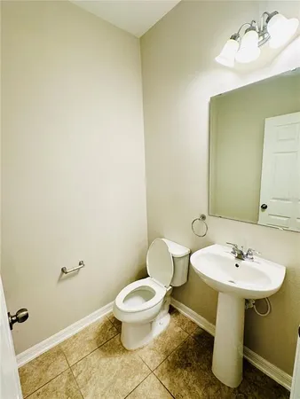 a white toilet sitting next to a bathroom sink