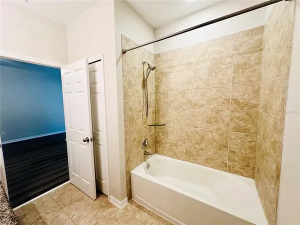 a bathroom with a granite countertop sink a toilet and mirror