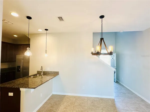 a view of a kitchen with a sink and a wooden floor