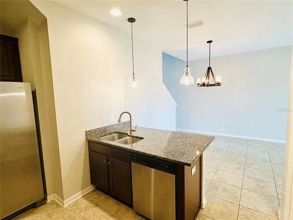 a kitchen with a sink a counter space and appliances