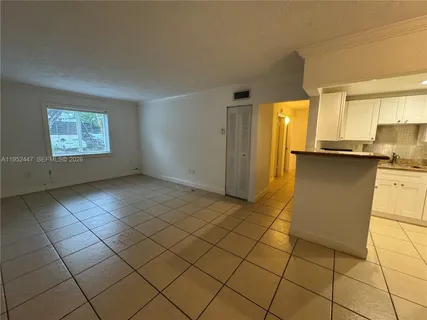 a view of a kitchen with furniture and a window