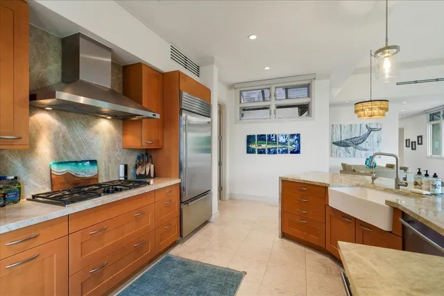 a kitchen with stainless steel appliances granite countertop a sink stove and cabinets