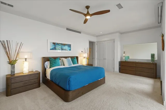 a bedroom with a bed a window and a chandelier