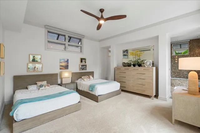 a bedroom with a bed and ceiling fan