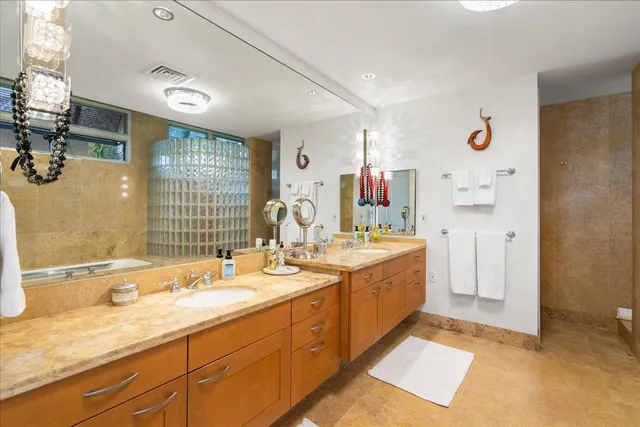 a spacious bathroom with a granite countertop sink and a mirror