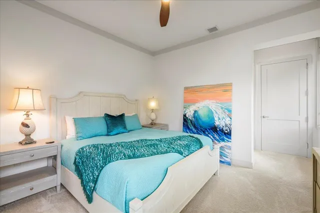 a bedroom with a large bed and a chandelier