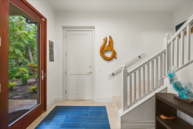 a view of a hallway with wooden floor and door