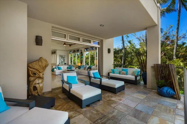 a building outdoor space with patio furniture and potted plants