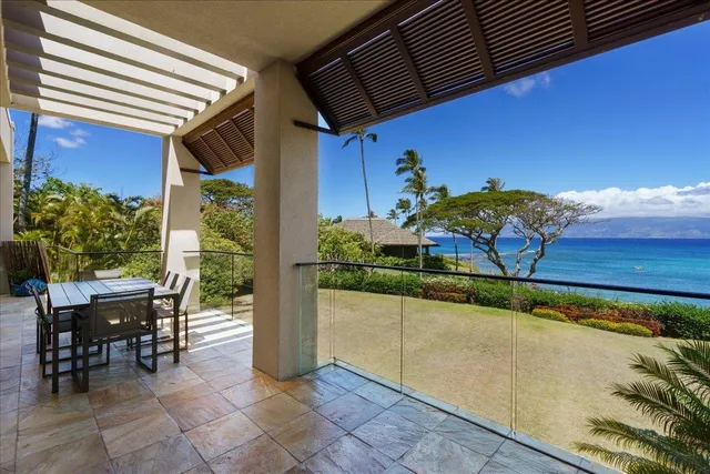 a view of a patio with table and chairs potted plants