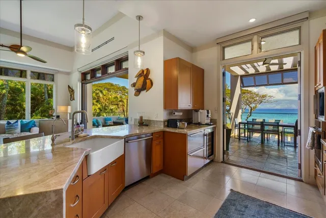 a kitchen with stainless steel appliances granite countertop sink stove and large window