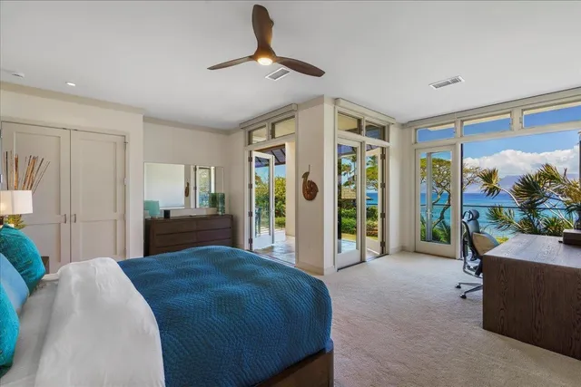 a spacious bedroom with a bed and a large window