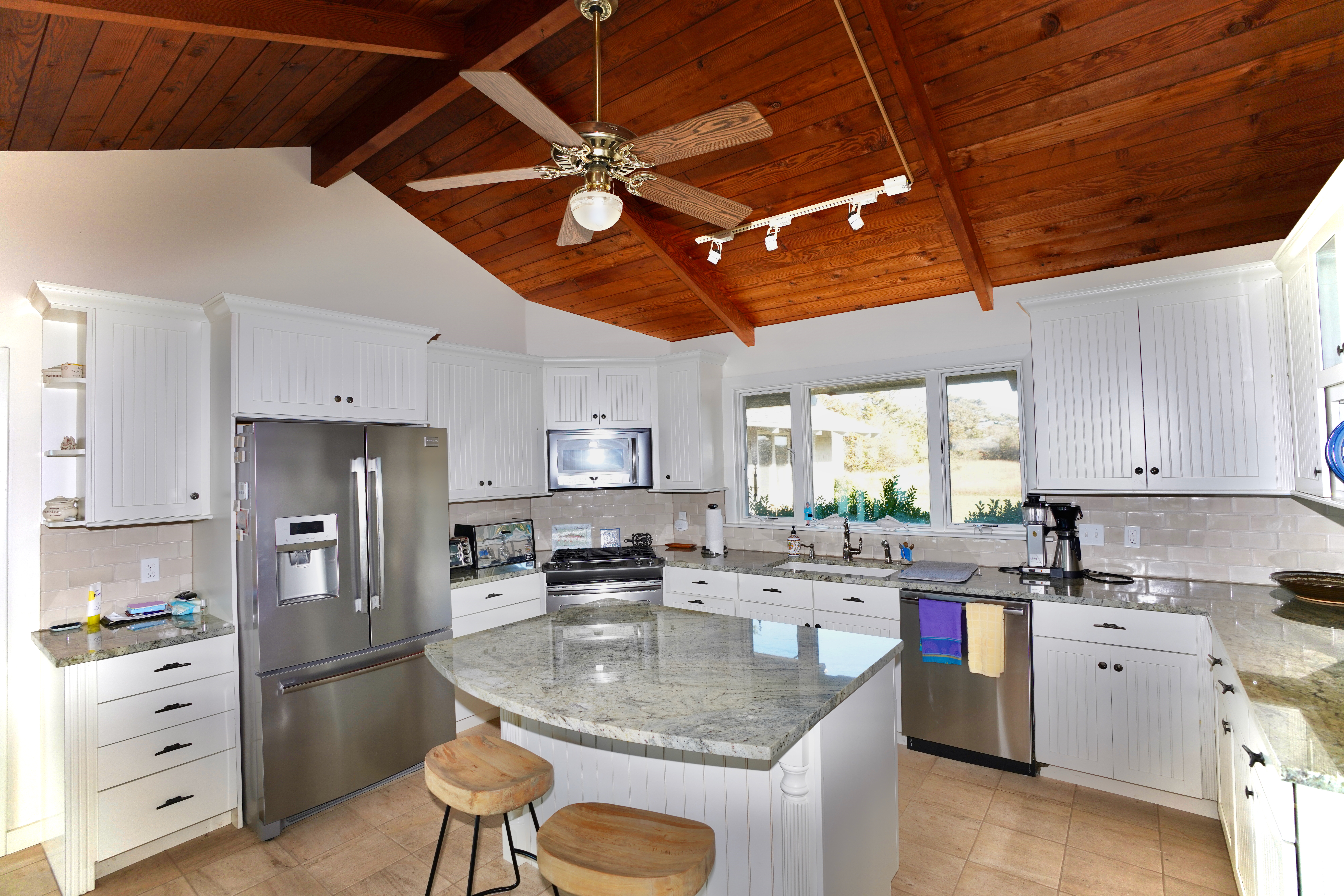 30 Calebs Pond Road Edgartown, MA 02539 - Photo 14 of 35 a kitchen with stainless steel appliances granite countertop a sink window and cabinets