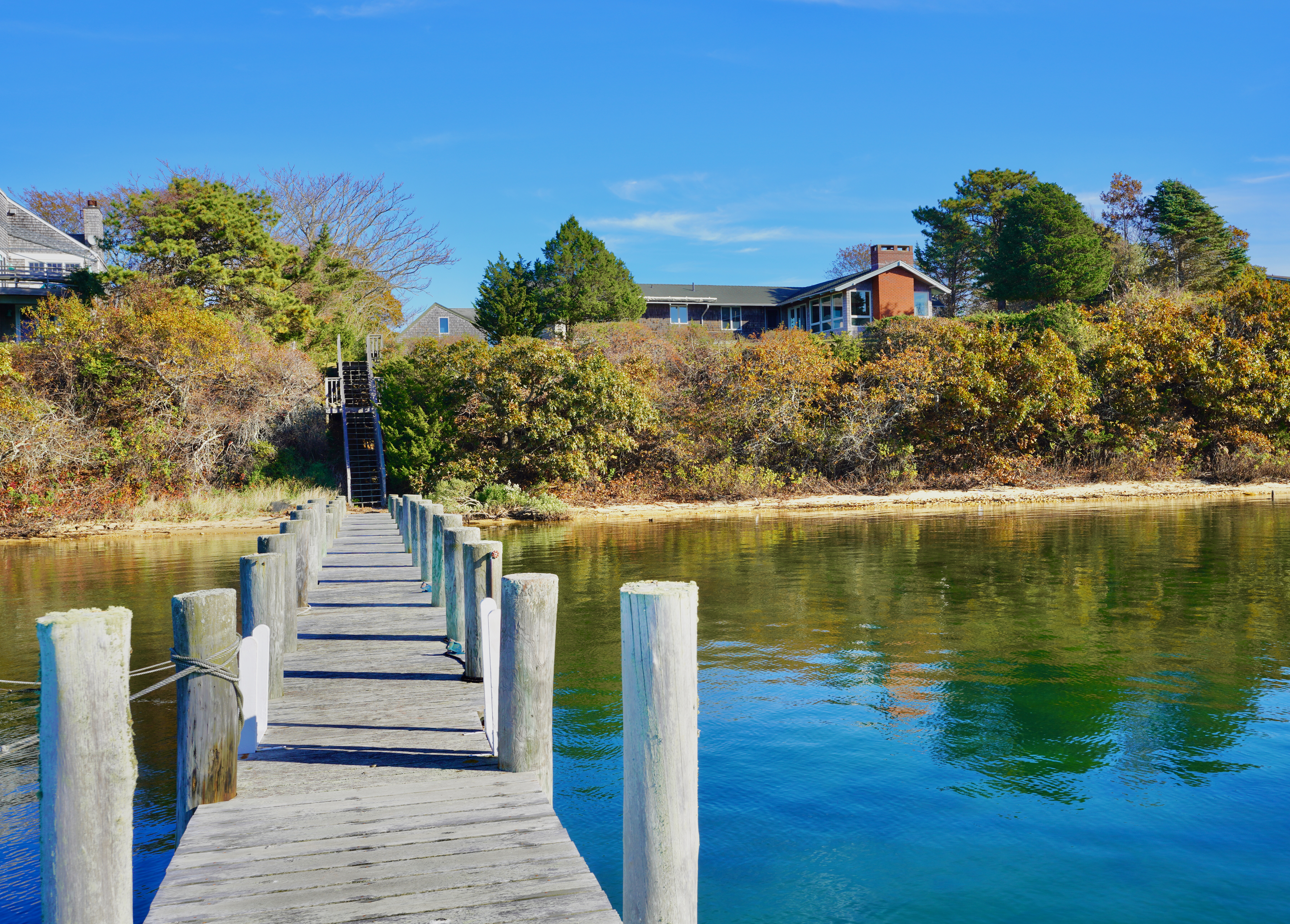 30 Calebs Pond Road Edgartown, MA 02539 - Photo 21 of 35 a view of a lake with a house in the background