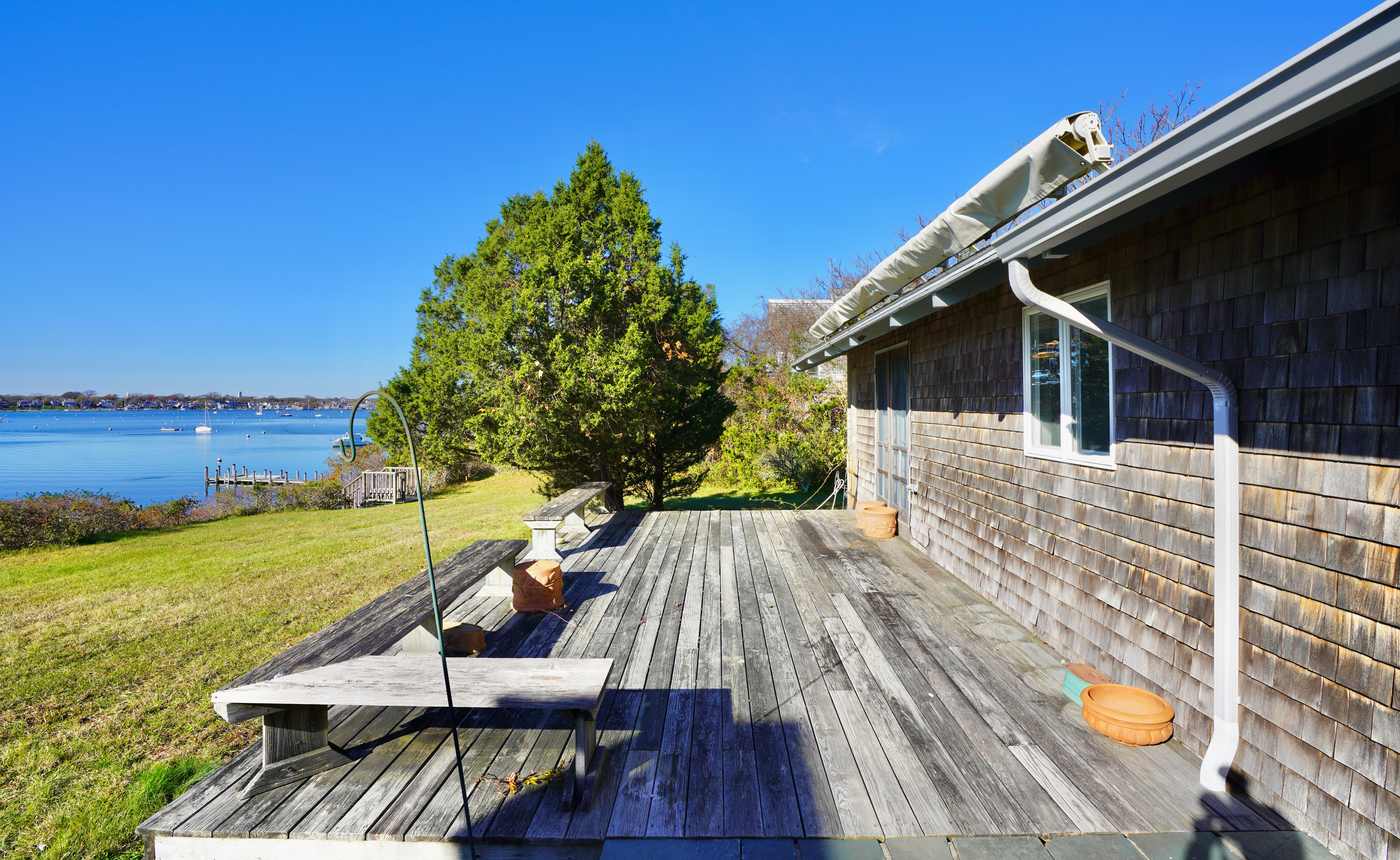 30 Calebs Pond Road Edgartown, MA 02539 - Photo 27 of 35 a view of a chairs and table on the wooden floor