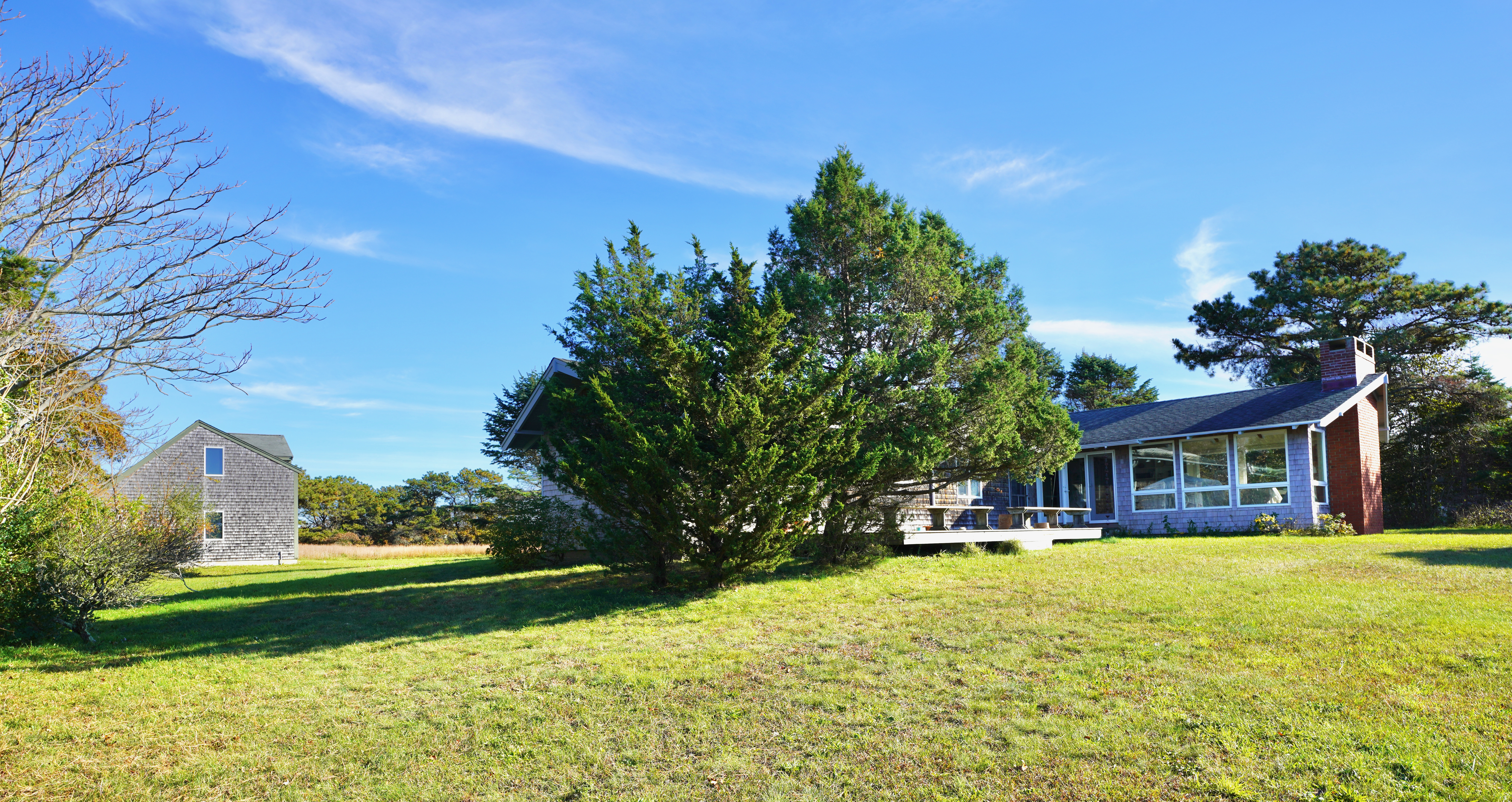 30 Calebs Pond Road Edgartown, MA 02539 - Photo 28 of 35 a house view with swimming pool and trees in the background